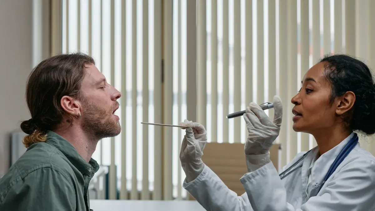 A veterinarian gently palpating a dog's abdomen during an exam